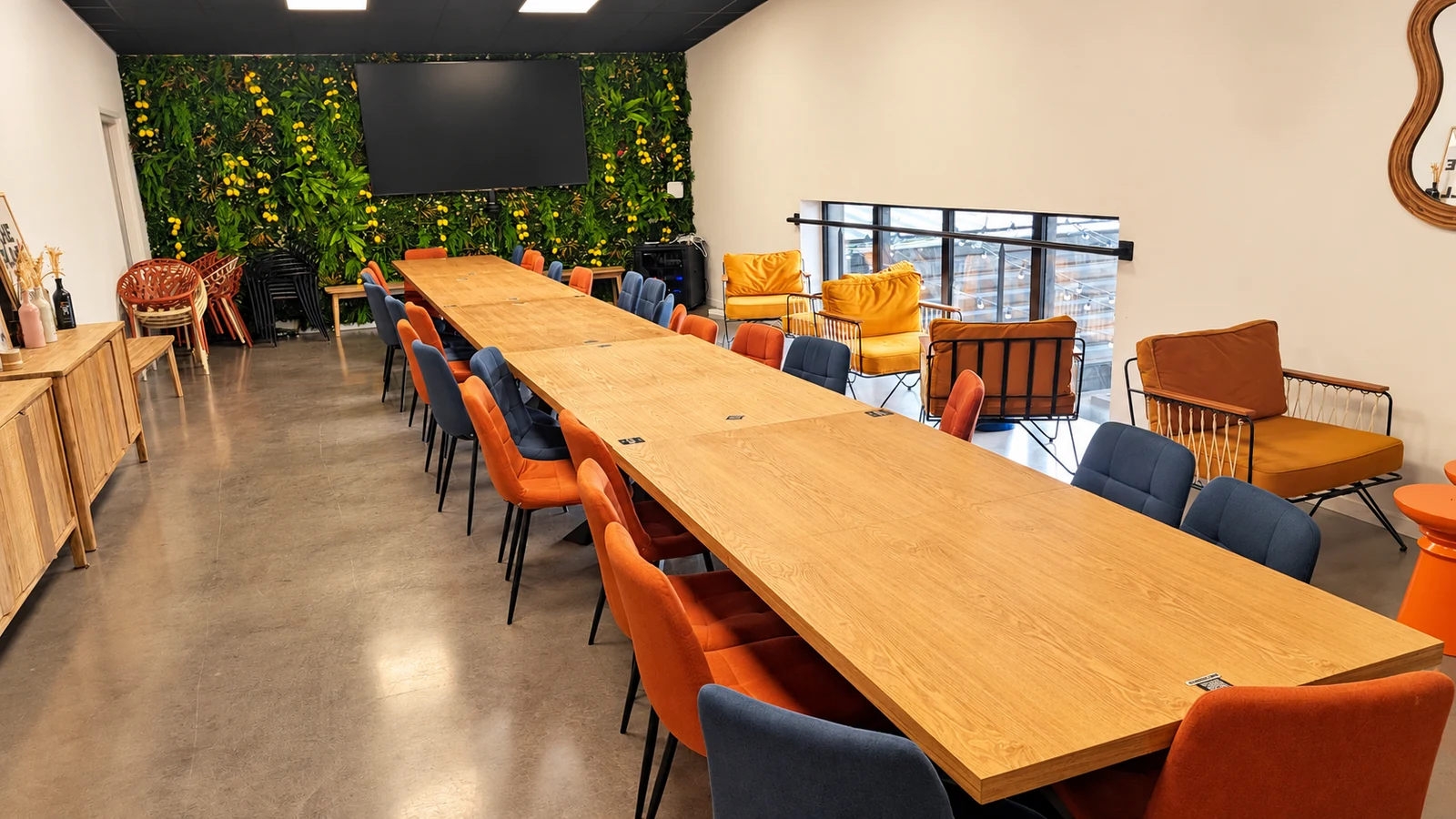 Salle de réunion Henri Food Court à Lescar, avec une grande table, des chaises, un écran et un coin salon.